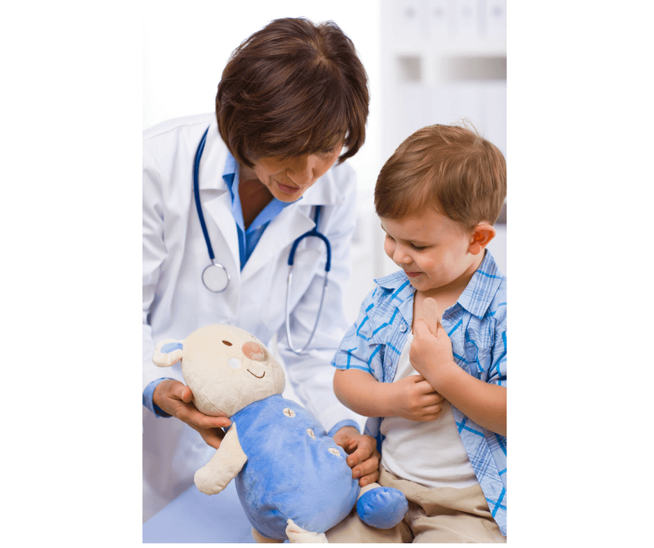doctor and child playing in the office with stuffed animal